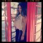 Casually dressed McKayla Maroney in a phone booth in London